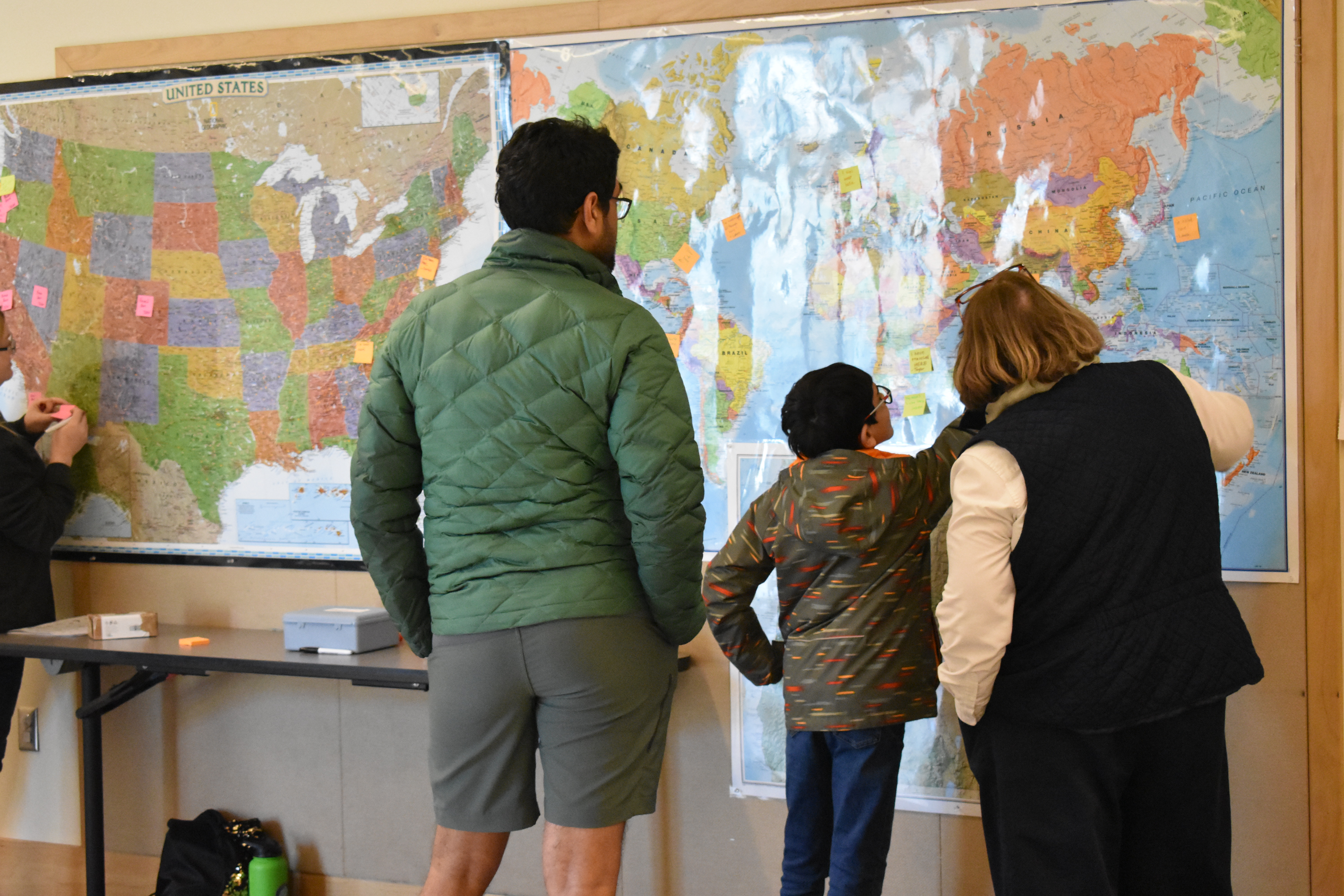 people looking at maps on the wall
